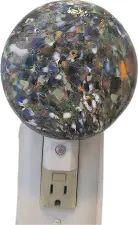 Speckled glass nightlight on a wall plug