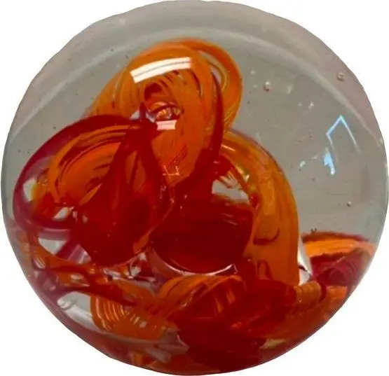 Round paperweight with a red-orange twist inside